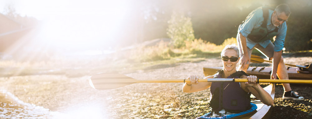 A-lady-kayaking-in-the-shallow-seads-with-her-partner-landscape