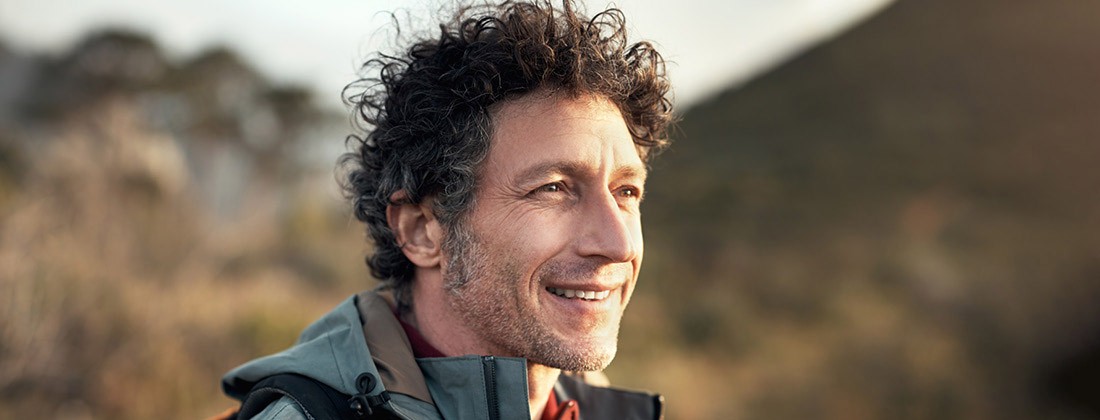 Man smiling hiking in nature