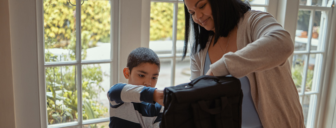 Parent Gets Child Ready For School 